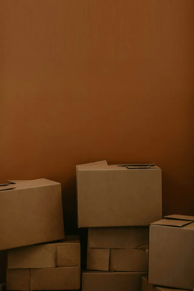 Stacked cardboard cartons, the shape and scale of what arrives on delivery day